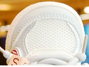 Close-up of white breathable mesh toddler shoe with synthetic leather trim and S logo