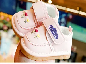 Close-up of pink baby walking shoes with tulip embroidery and non-slip rubber soles