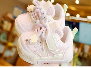 Close-up of pink breathable mesh toddler shoes with cute bear charm and velcro straps
