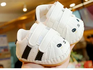 Detail of baby walking shoes with panda embroidery and anti-slip rubber soles