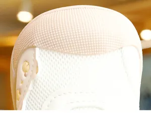 Detailed close-up of anti-collision rubber toe and breathable mesh on infant walking shoes