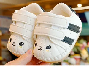 Detail of baby walking shoes with panda embroidery and double hook-and-loop straps