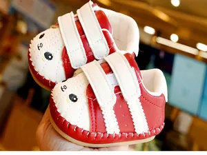 Detail of baby walker shoes featuring red-white contrast and panda embroidery