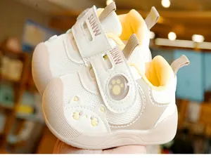 Detail of baby walking shoes with breathable mesh, cat pattern and toe protection