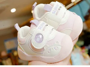 Close-up of pink toddler walking shoes with breathable mesh and cute bear pattern