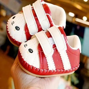 Red baby sneakers with cartoon animal face, soft rubber sole and white velcro straps
