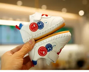 Detail of baby walking shoe with non-slip rubber sole and colorful smiley embroidery
