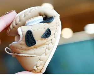 Close-up showing the soft flexible sole and khaki leather of the infant walking shoes