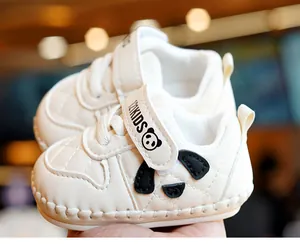 Close-up of panda face design on cream baby walking shoes with quilted leather details