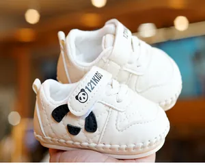 Detail of baby soft-sole walking shoes with velcro strap and cute panda pattern