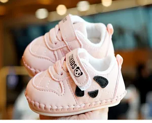 Close-up of pink soft sole baby walking shoes with panda ears and velcro strap
