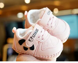 Macro detail of baby soft sole walker with panda design and quilted faux leather texture