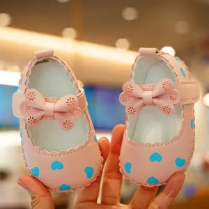 Pink infant princess walker shoes with heart patterns and laser-cut bow detail