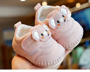 Close-up of pink baby walking shoe featuring a cute koala design and velcro strap