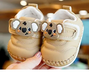 Close-up of baby walking shoes with cute 3D koala cartoon decoration and soft white sole