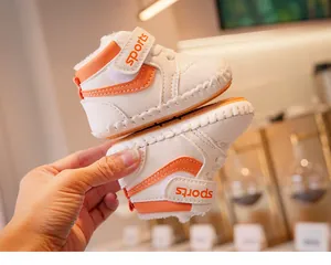 Close-up of baby high-top fleece shoes with soft sole, orange stripes and velcro straps