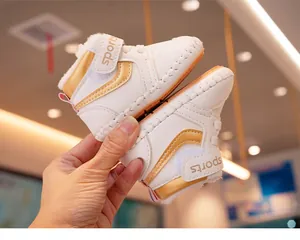 Close-up of baby winter sneakers with thick faux fur lining and velcro sports strap