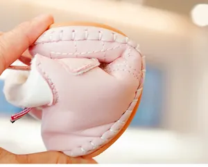 Detail showing high flexibility and non-slip rubber sole of pink fleece baby walking shoes