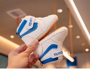Detail of baby soft sole sports shoes with blue stripes, warm fur lining, and velcro strap