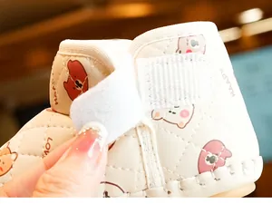 Detail of quilted baby shoes with warm plush lining and adjustable hook-and-loop strap