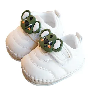 Cute white baby walking shoes with green koala decoration and soft non-slip soles