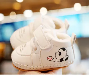 Detailed view of white baby winter shoes with warm fleece lining and panda print
