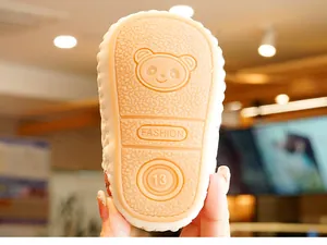 Macro shot of non-slip rubber baby shoe sole with embossed panda and size 13 mark