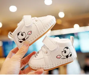Detail of warm white baby walker shoes with panda pattern and cozy fleece lining