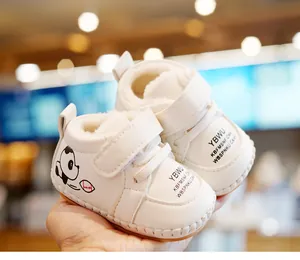 Detail showing the thick faux lamb wool lining and plush interior of white baby winter shoes