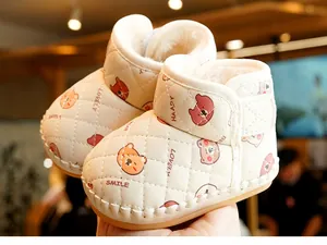 Detail of warm baby winter boots with thick fleece lining and cartoon bear patterns