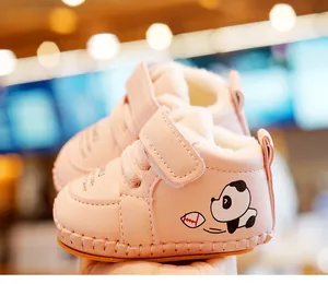 Detail of pink baby walking shoes with plush lining and velcro strap closure