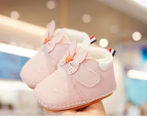 Detail of pink baby walking shoe with rabbit ears, fleece lining and velcro closure