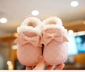 Detailed view of pink baby winter shoes with textured leather and soft fleece lining