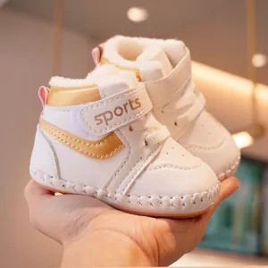 Warm white fleece-lined baby walking shoes with gold accents and velcro strap closure
