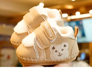 Detailed view of fleece-lined baby winter boots with cute bear embroidery and sequin stripes