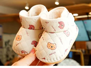 Detail of warm winter baby shoes featuring soft cream fleece lining and bear patterns
