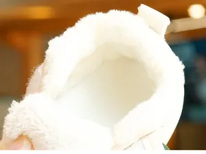Close-up of thick white faux fur lining for warm winter baby shoes with soft texture