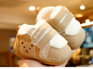 Macro detail of baby winter boot featuring bear embroidery and plush lining