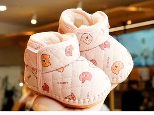 Detailed view of pink baby walking shoes with warm fleece lining and cute bear print