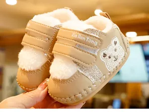 Detail of baby winter shoes with thick plush lining, bear embroidery, and velcro closure