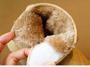 Close-up of thick plush lining and velcro closure on beige winter toddler boots
