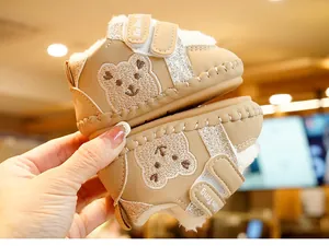 Close-up of baby walking shoes with warm fleece lining and bear embroidery detail