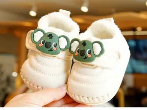 Detail of warm baby walking boot with faux fur lining and green koala velcro strap