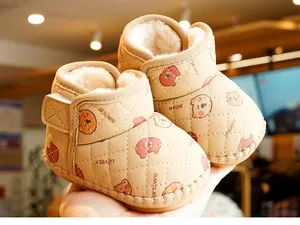 Detail of warm winter baby boots with soft fleece lining and cartoon bear pattern
