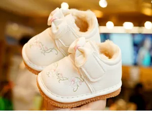 Close-up of baby winter walking shoes with floral embroidery and thick fleece lining