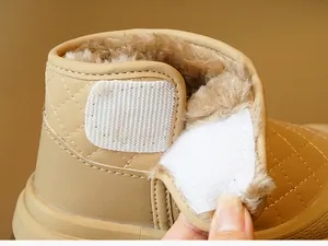 Close-up of baby winter boots with thick plush lining and quilted velcro strap