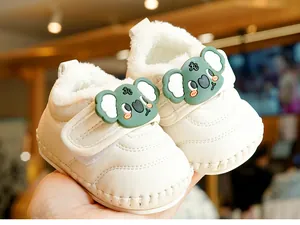 Detail of warm baby walking shoes with soft fleece lining and cute green koala decor