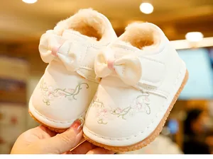 Detail of warm winter baby walker shoes with thick plush lining and floral embroidery