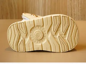 Macro shot of non-slip rubber sole with deep grooves and size 22 marking on baby shoes