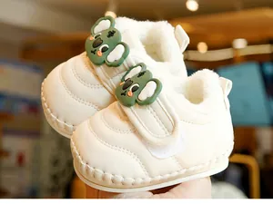 Close-up of baby winter walking shoe with warm fleece lining and green koala decor
